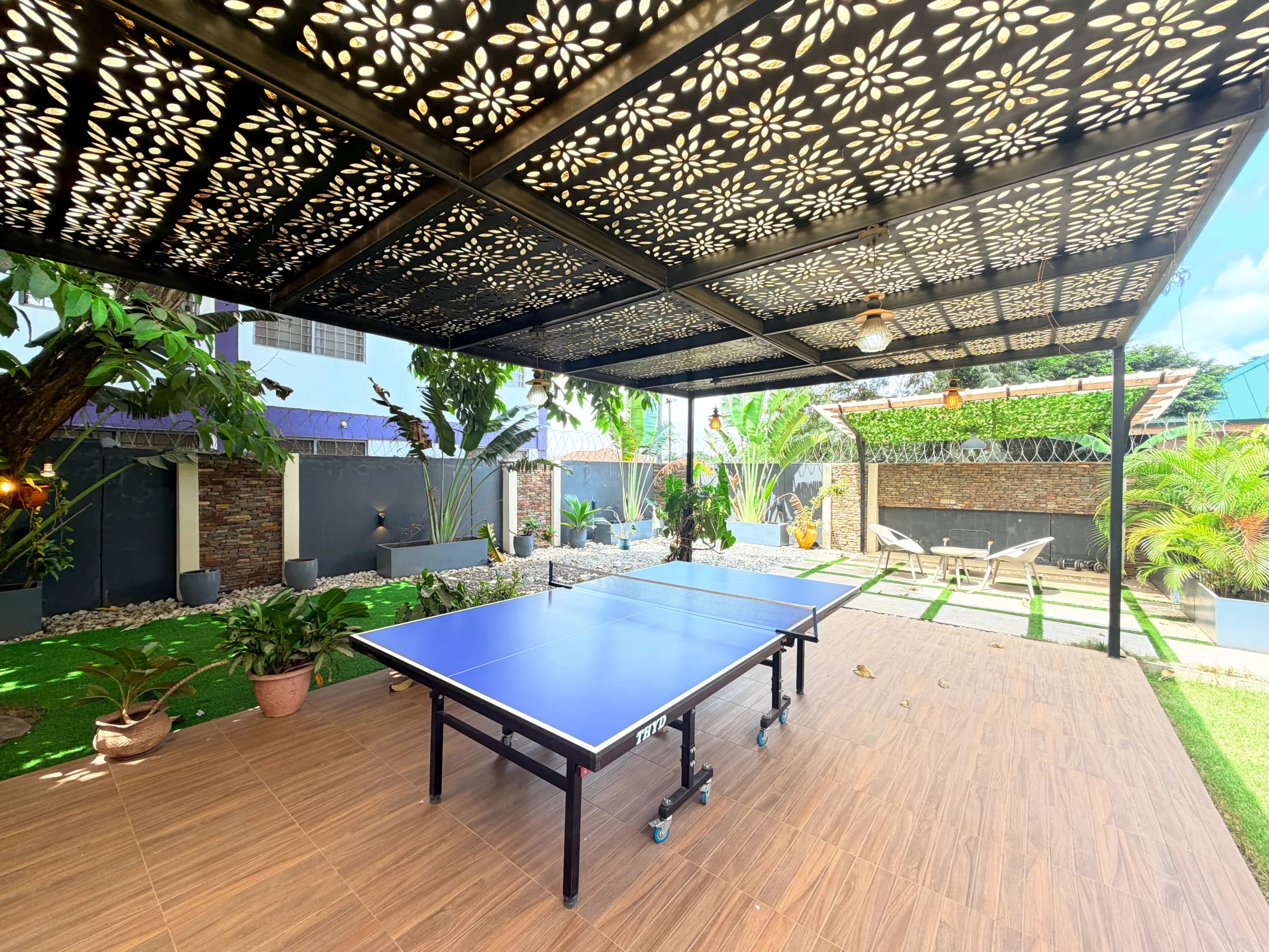A table tennis table under the covered terrace