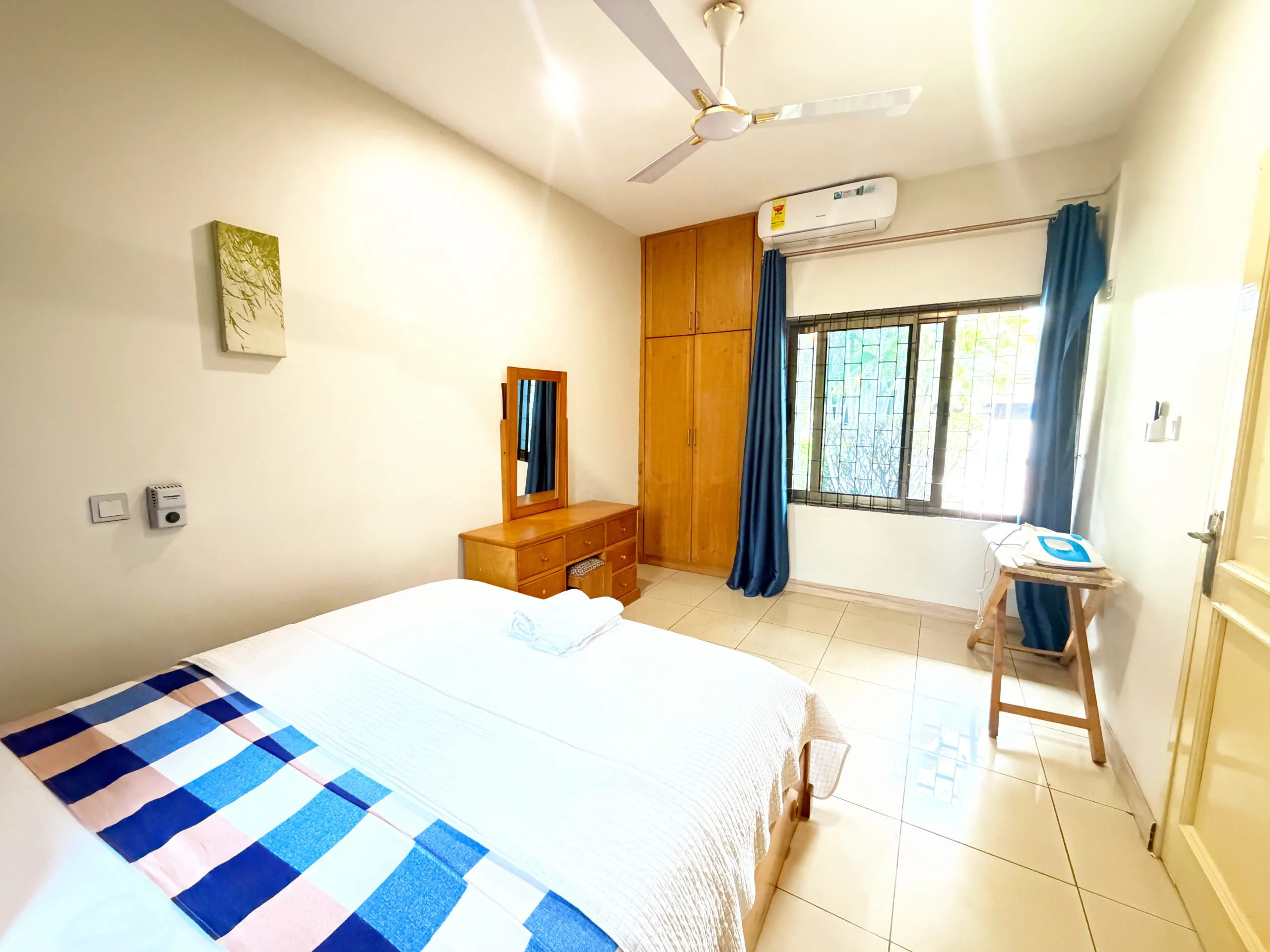 A double bed beside a fitted wardrobe