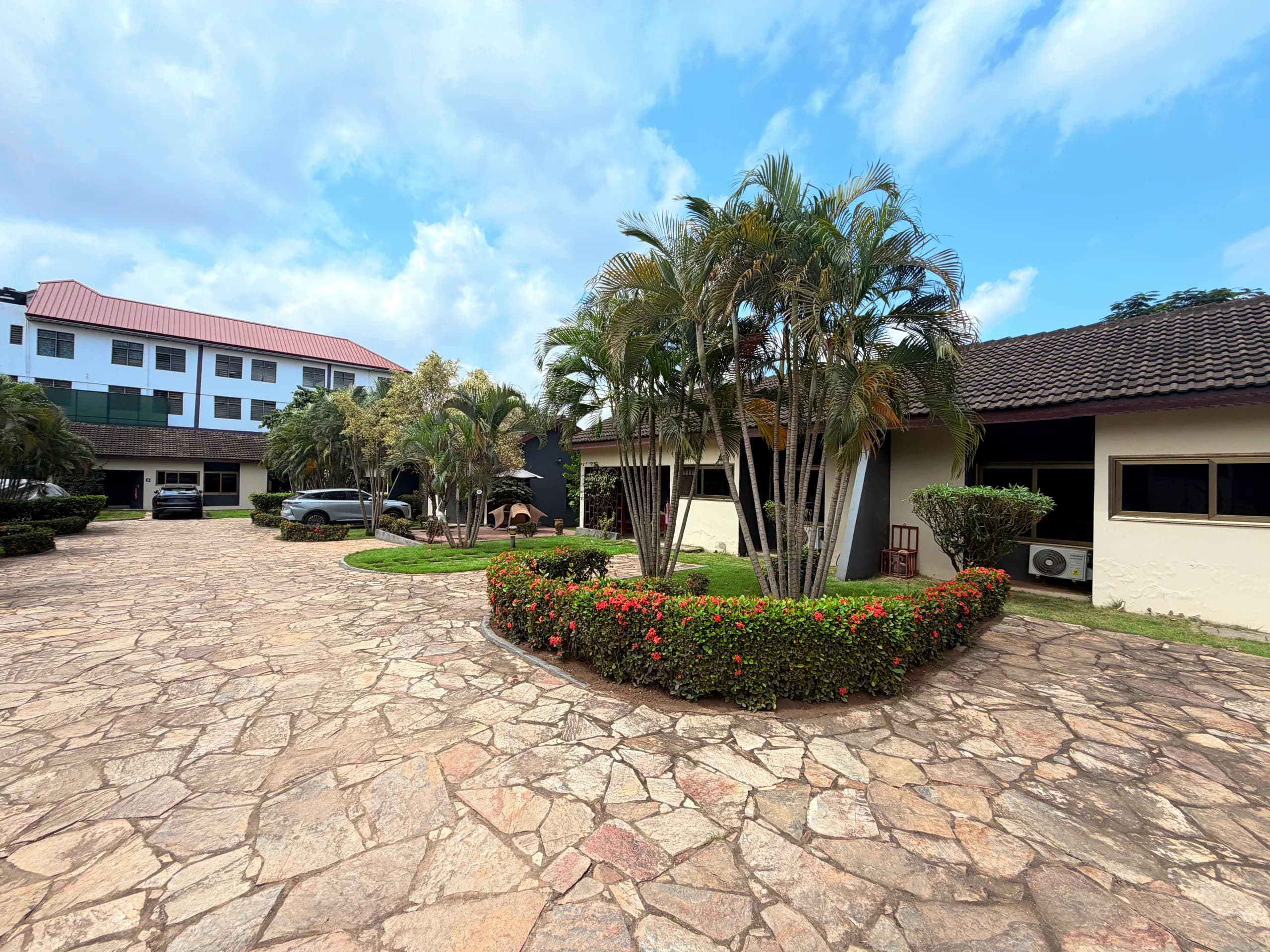 Clipped hedges and palms around the courtyard