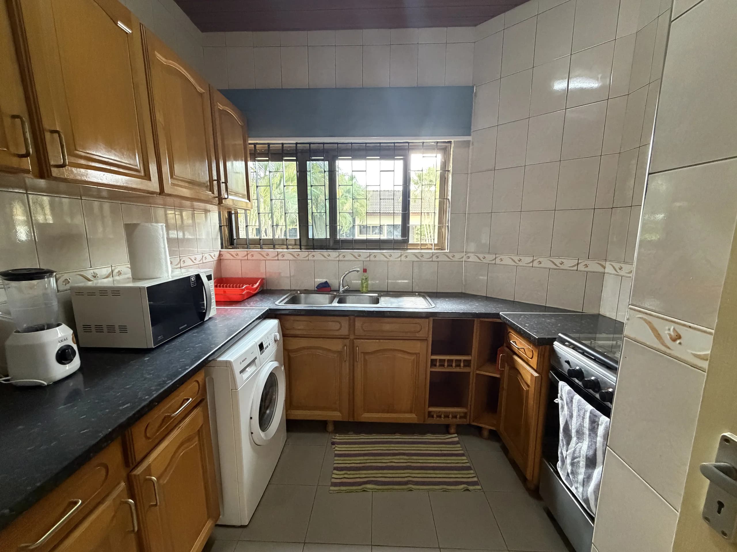 A kitchen with a gas cooker and fitted cupboards