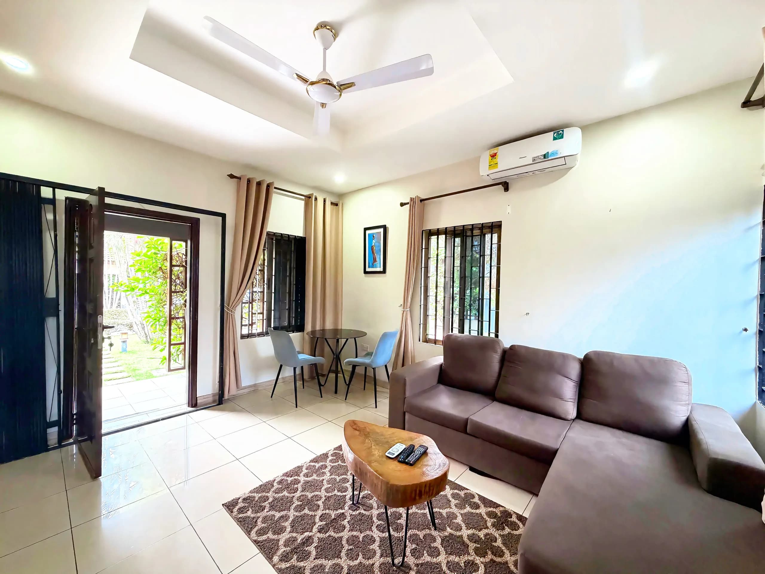 A brown sofa beside doors onto the terrace