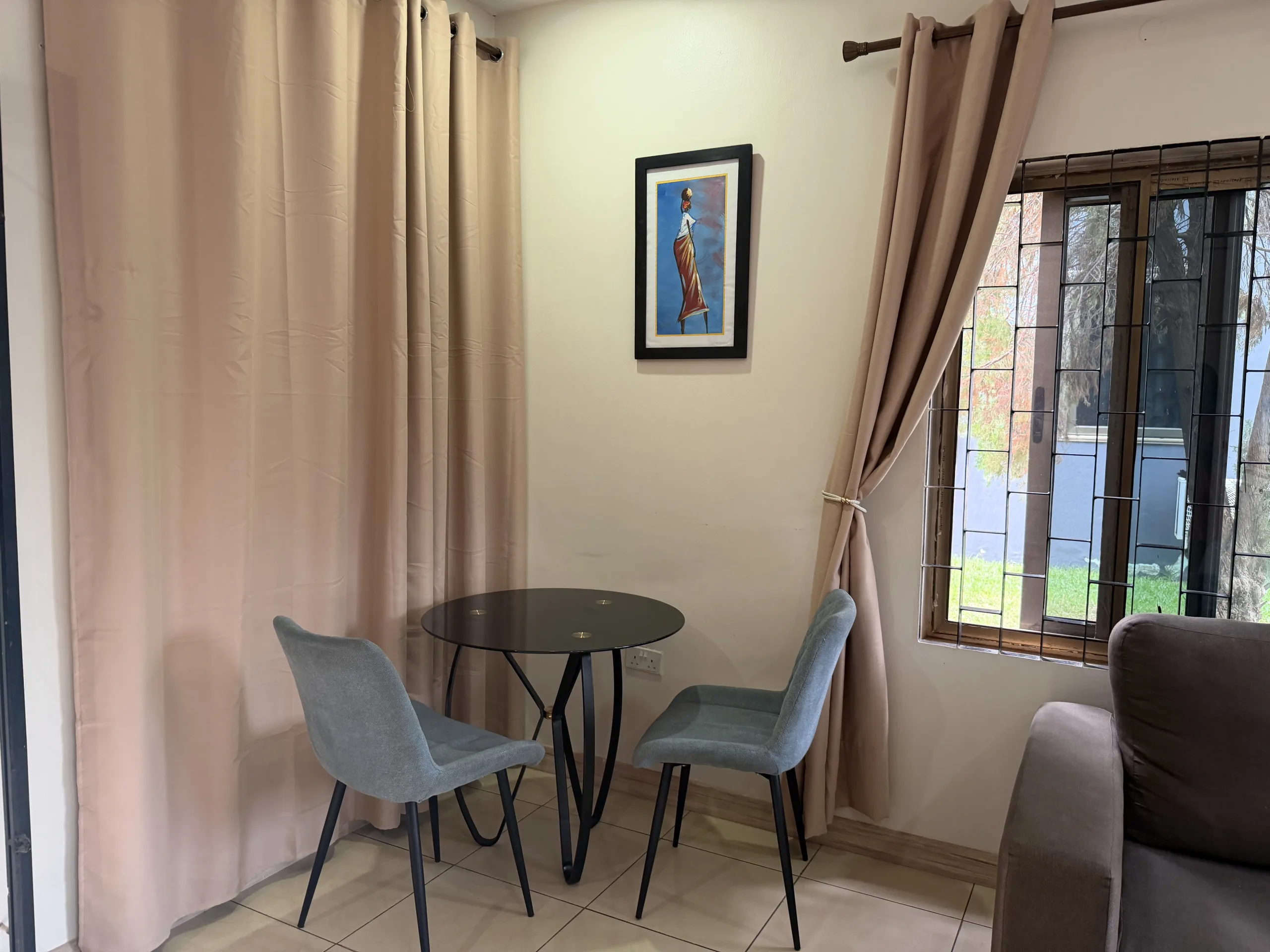 A dining table for two beside the window
