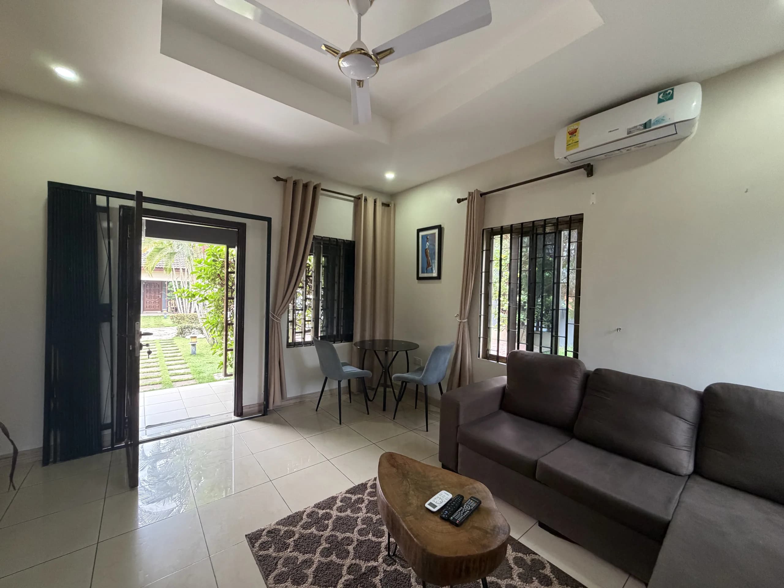 A living room with garden doors and a dining set