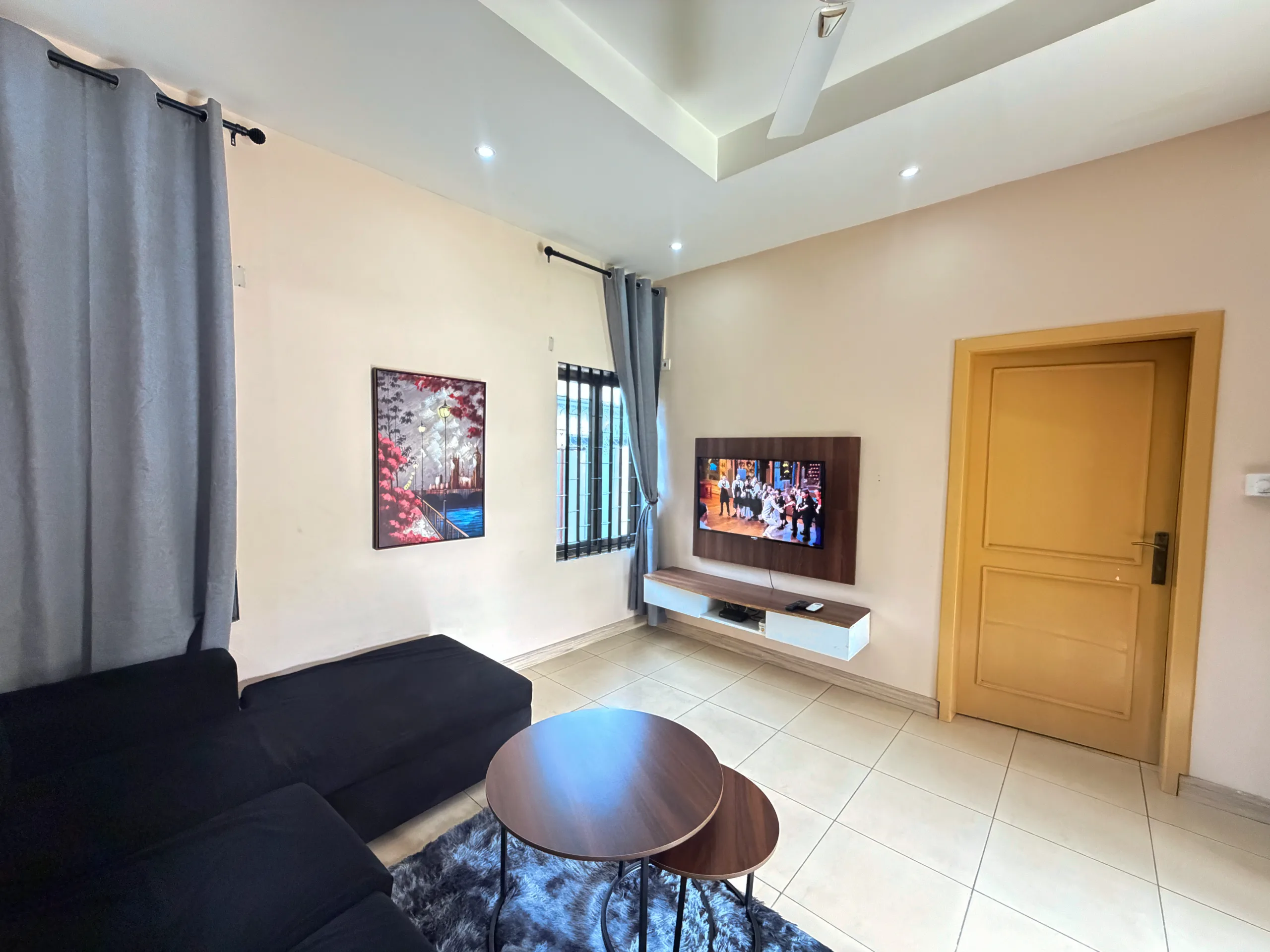 A sitting area with television and artwork
